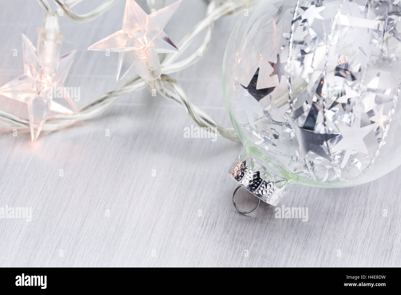 Glass Christmas ball on abstract light background closeup Stock Photo