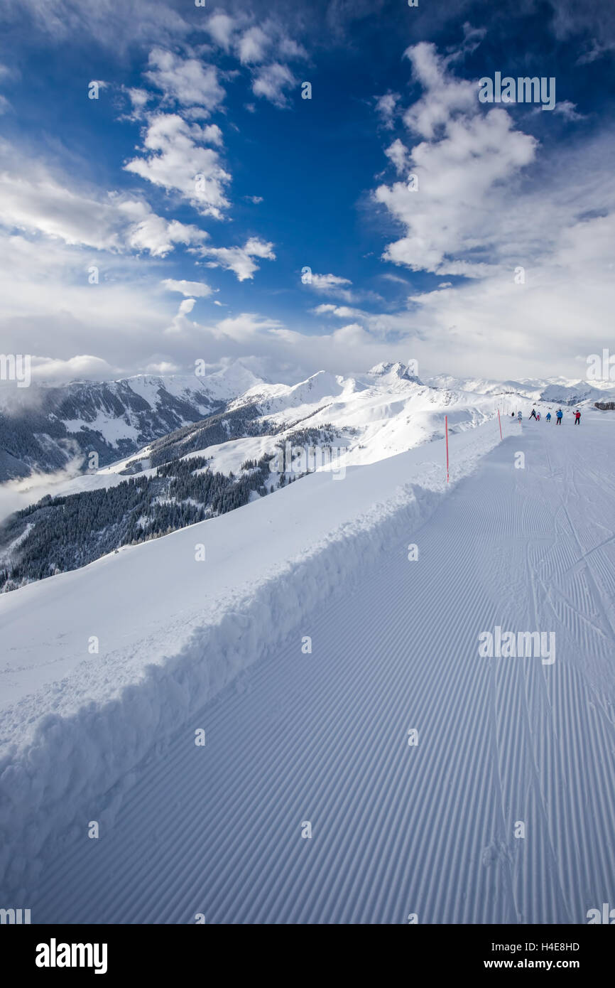 Skiers skiing in Kitzbuehel ski resort and enjoying Tyrolian Alps, Austria Stock Photo