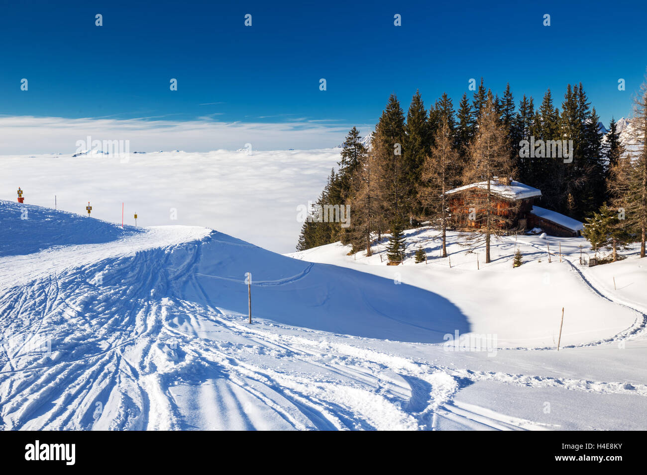 Alpine chalet covered by snow in Kitzbuehel ski arena, Austria Stock Photo