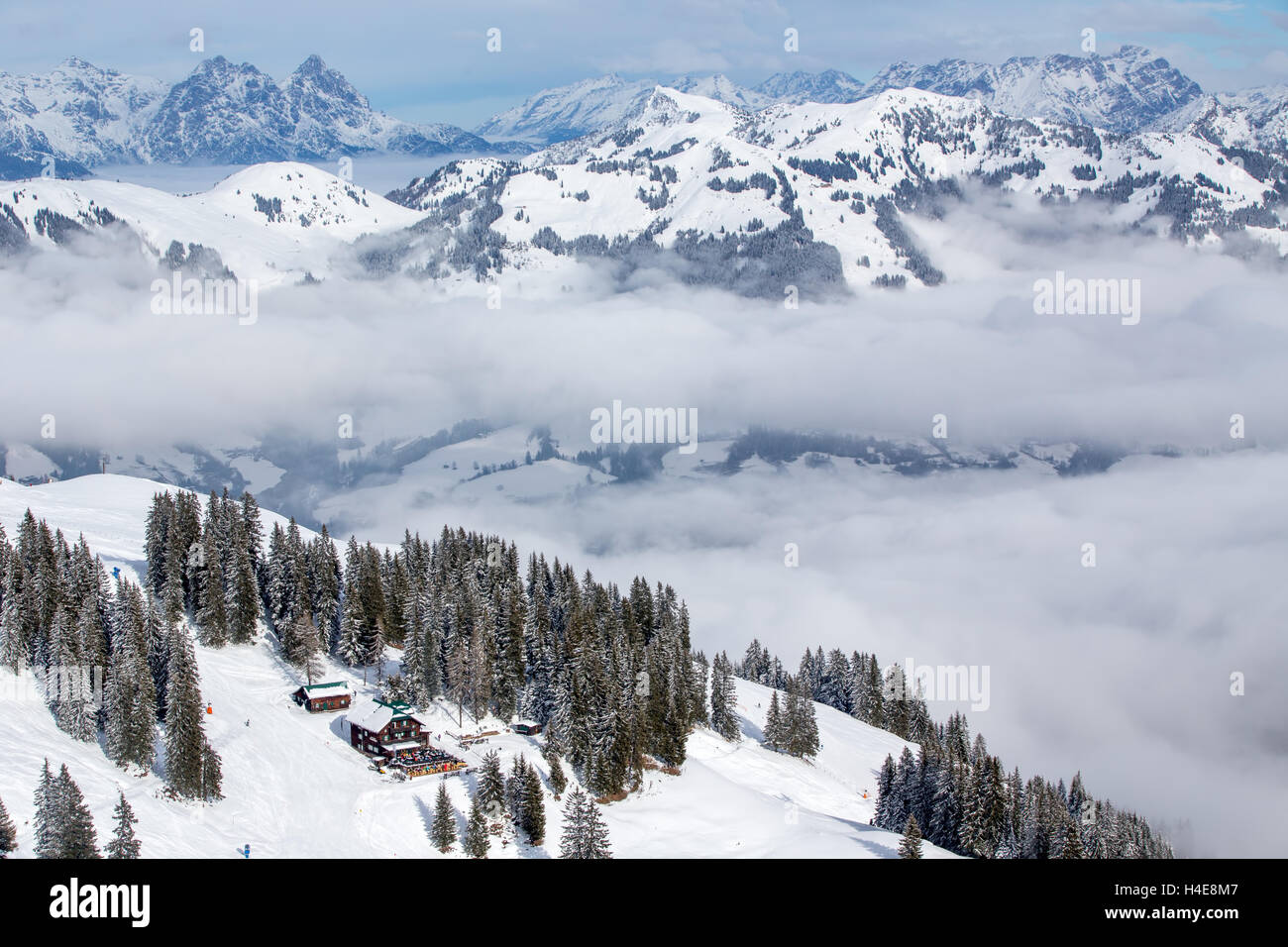 Tyrolian Alps covered by fresh snow in fog seen from the Kitzbuehel ski resort, Austria Stock Photo