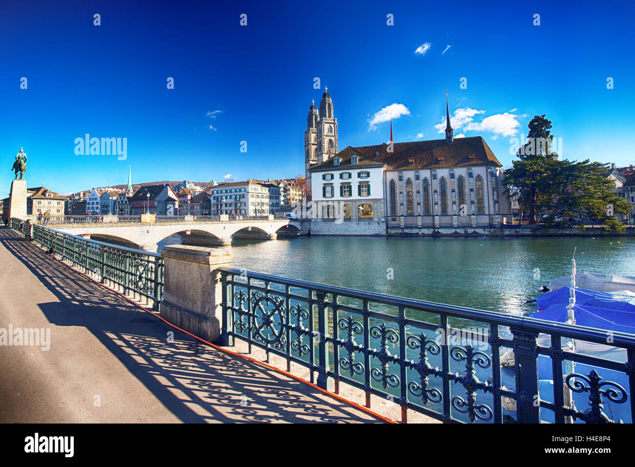 View of historic Zurich city center with famous Grossmunster Church and Limmat river Stock Photo