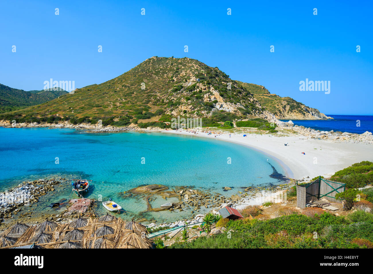 Punta Molentis bay with old fishing boats on sea water and beach view from top of a hill, Sardinia island, Italy Stock Photo