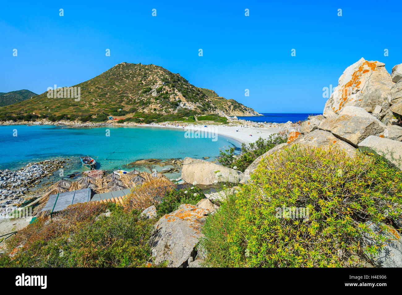 View of Punta Molentis bay with old fishing boats on sea water and