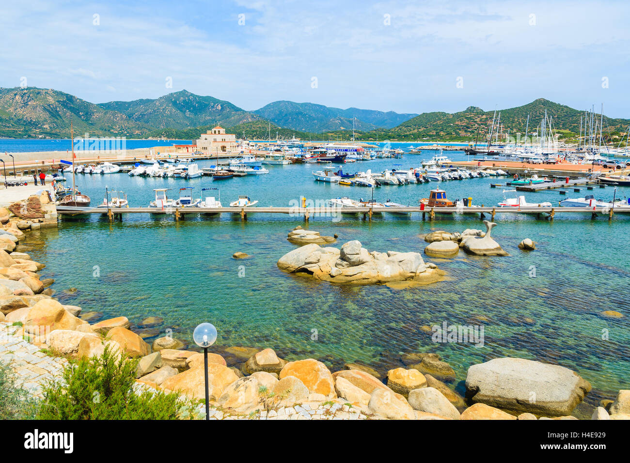 View of Porto Giunco touristic harbour with sailboats and yachts mooring, Sardinia island, Italy Stock Photo