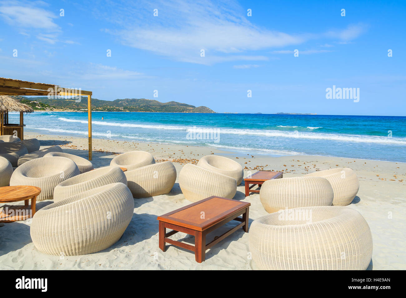 Chairs In A Beach Bar With Wooden Table On White Sand In Porto