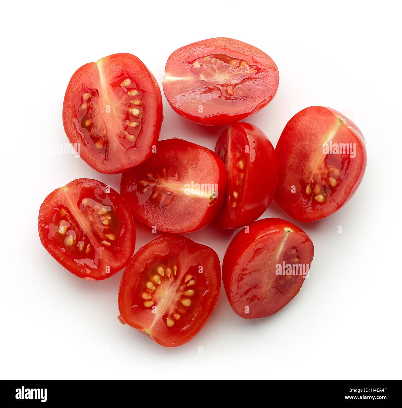 Heap of cherry tomato halves isolated on white background, top view Stock Photo