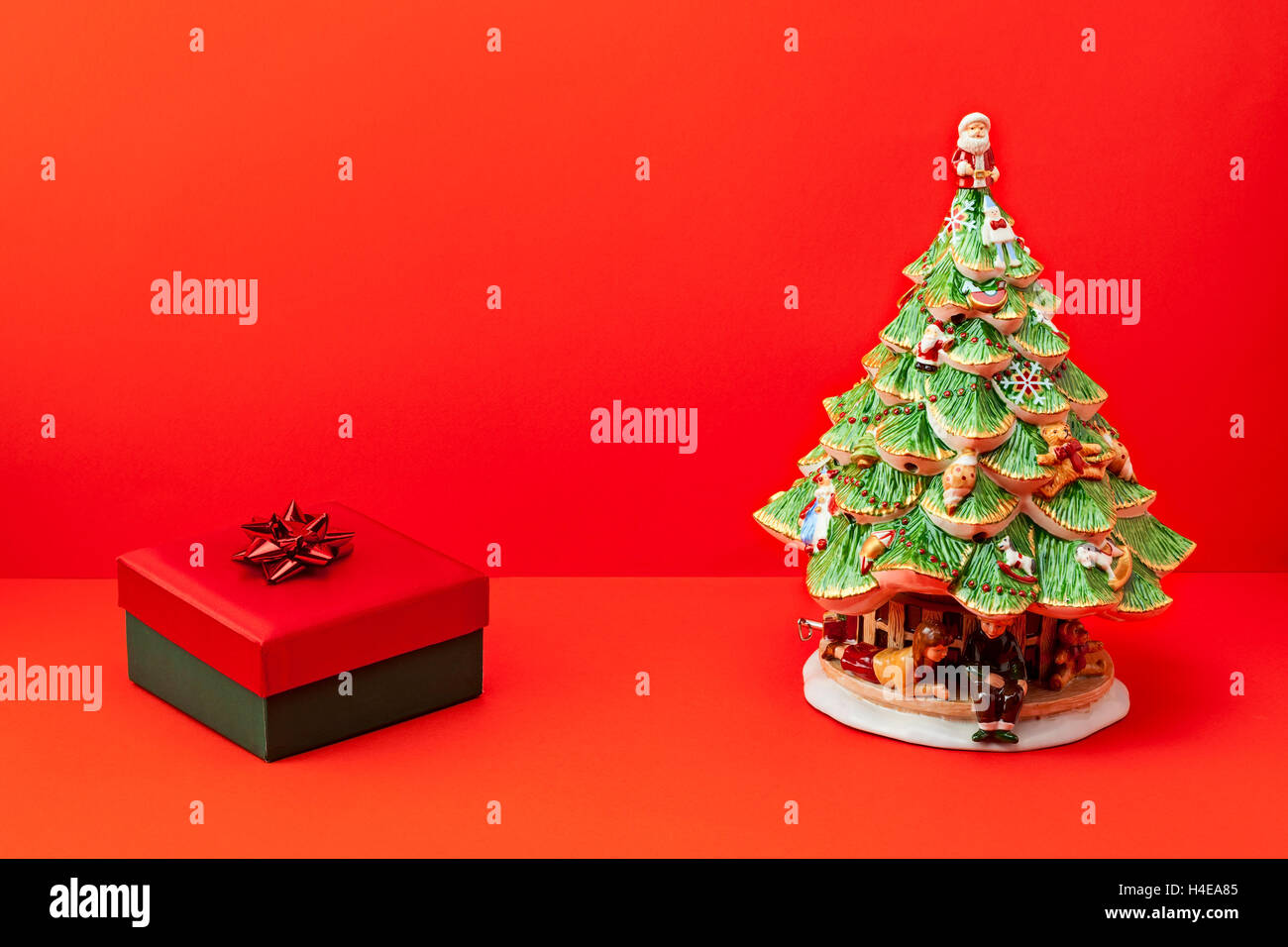 beautiful christmas gift and tree on red background Stock Photo - Alamy