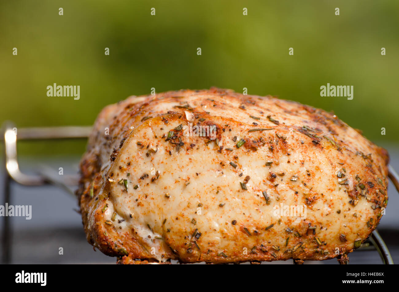 Pork roast on grill, sunny day, grass Stock Photo Alamy