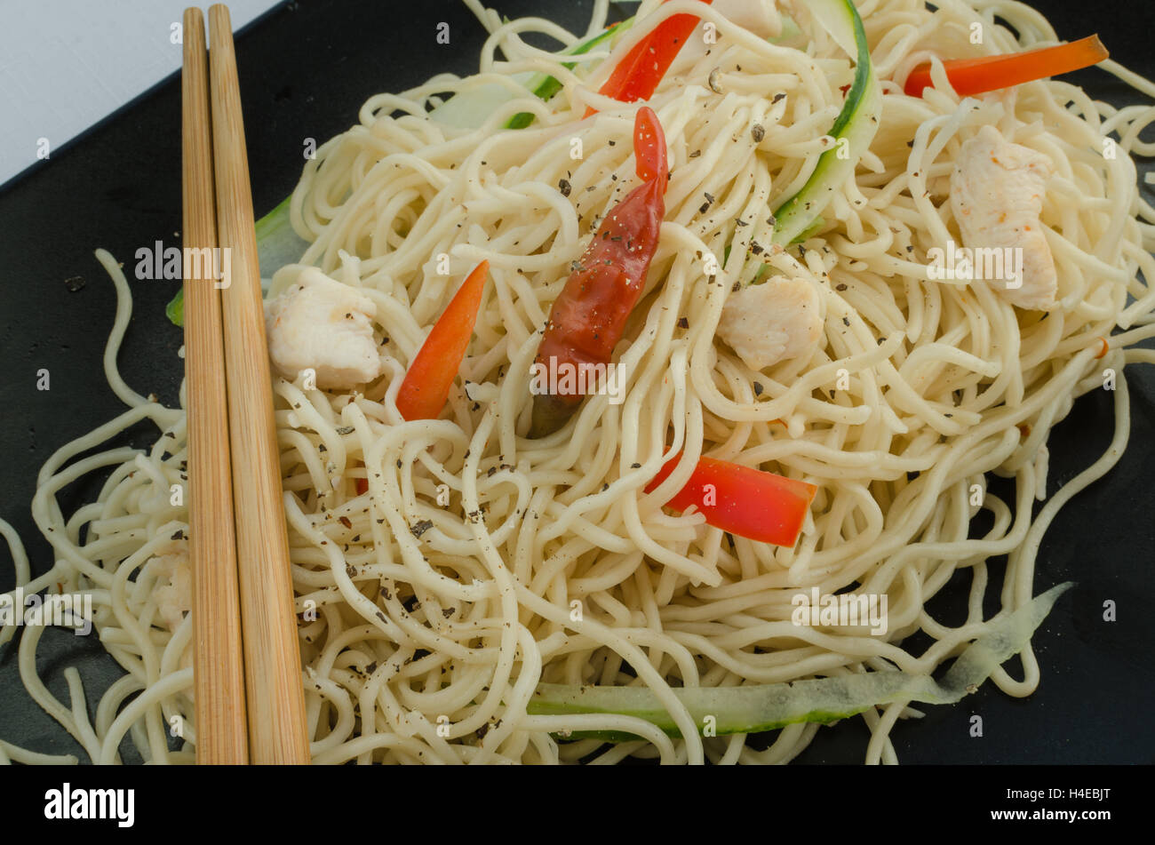 Chinese noodles, fast but delicious food with chopsticks Stock Photo
