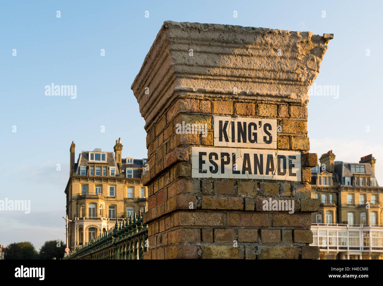 Old brick pillar with street sign on King's Esplanade and seafront