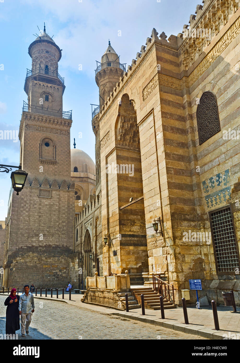 The high minarets covered with carved islamic patterns are the proud of Al-Muizz street in Islamic Cairo Egypt Stock Photo