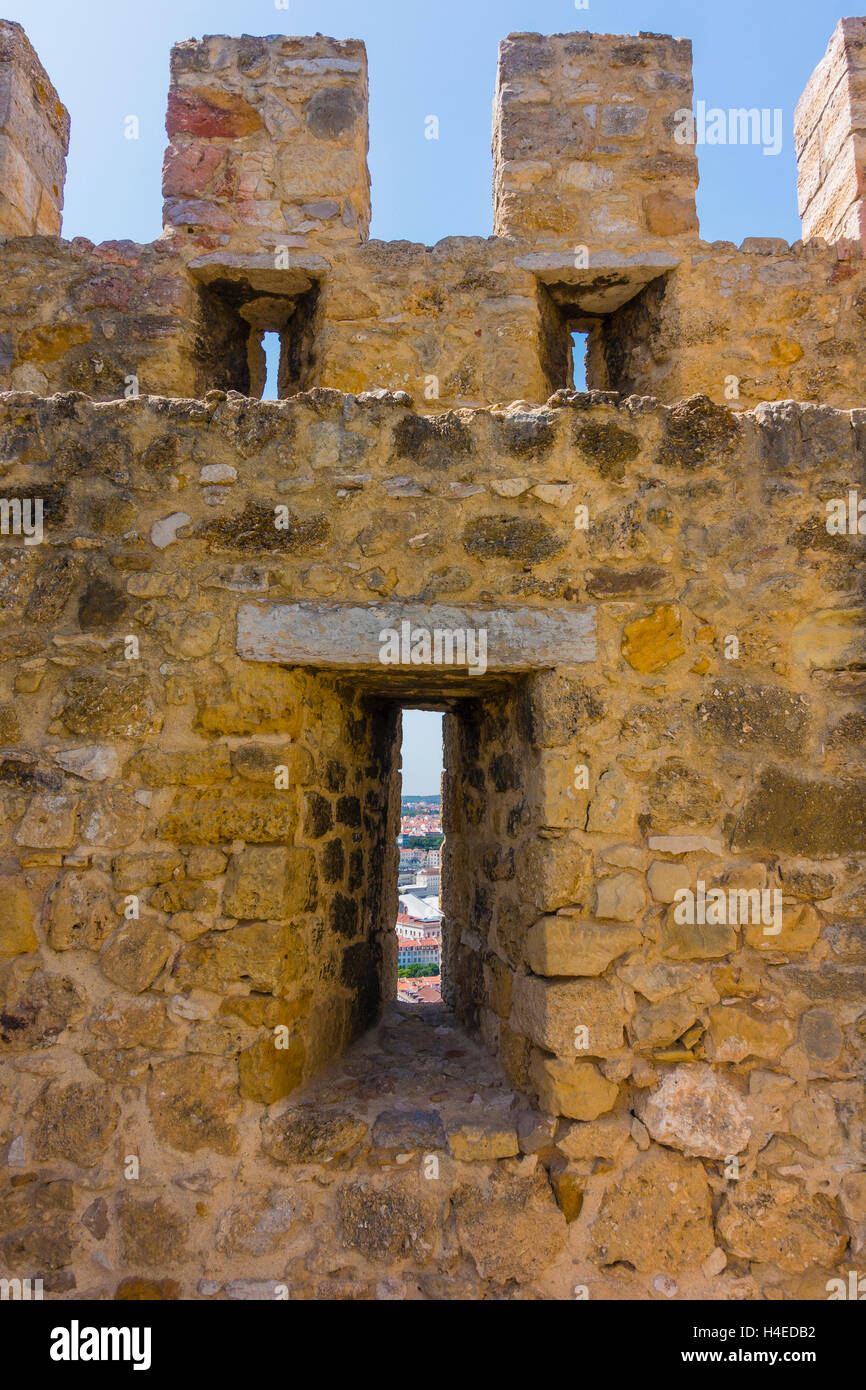 An arrowslit (arrow loop) and a view from a São Jorge Castle, Lisbon, Portugal. Stock Photo