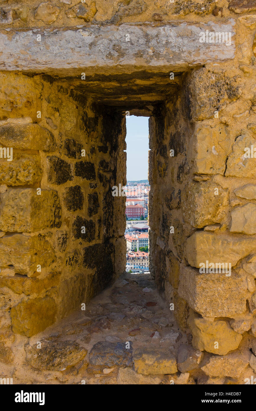 An arrowslit (arrow loop) and a view from a São Jorge Castle, Lisbon, Portugal. Stock Photo