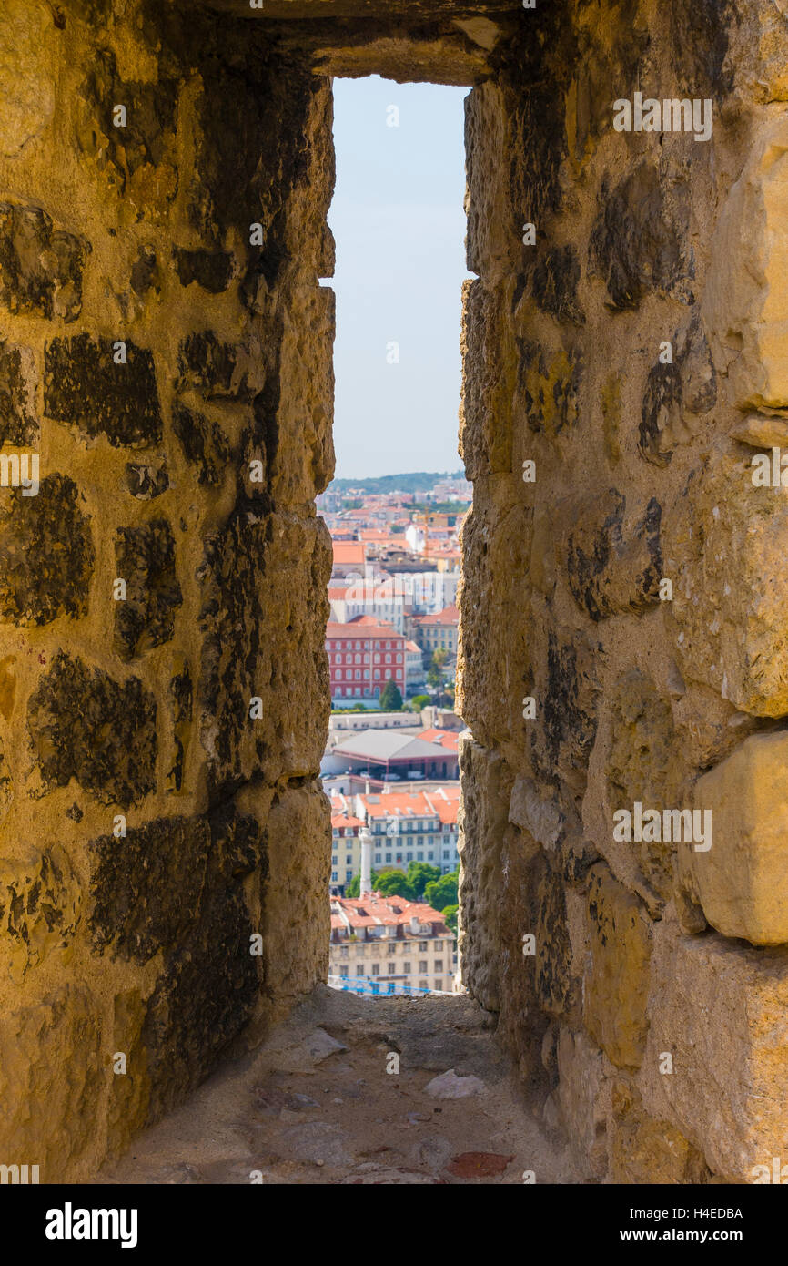 An arrowslit (arrow loop) and a view from a São Jorge Castle, Lisbon, Portugal. Stock Photo