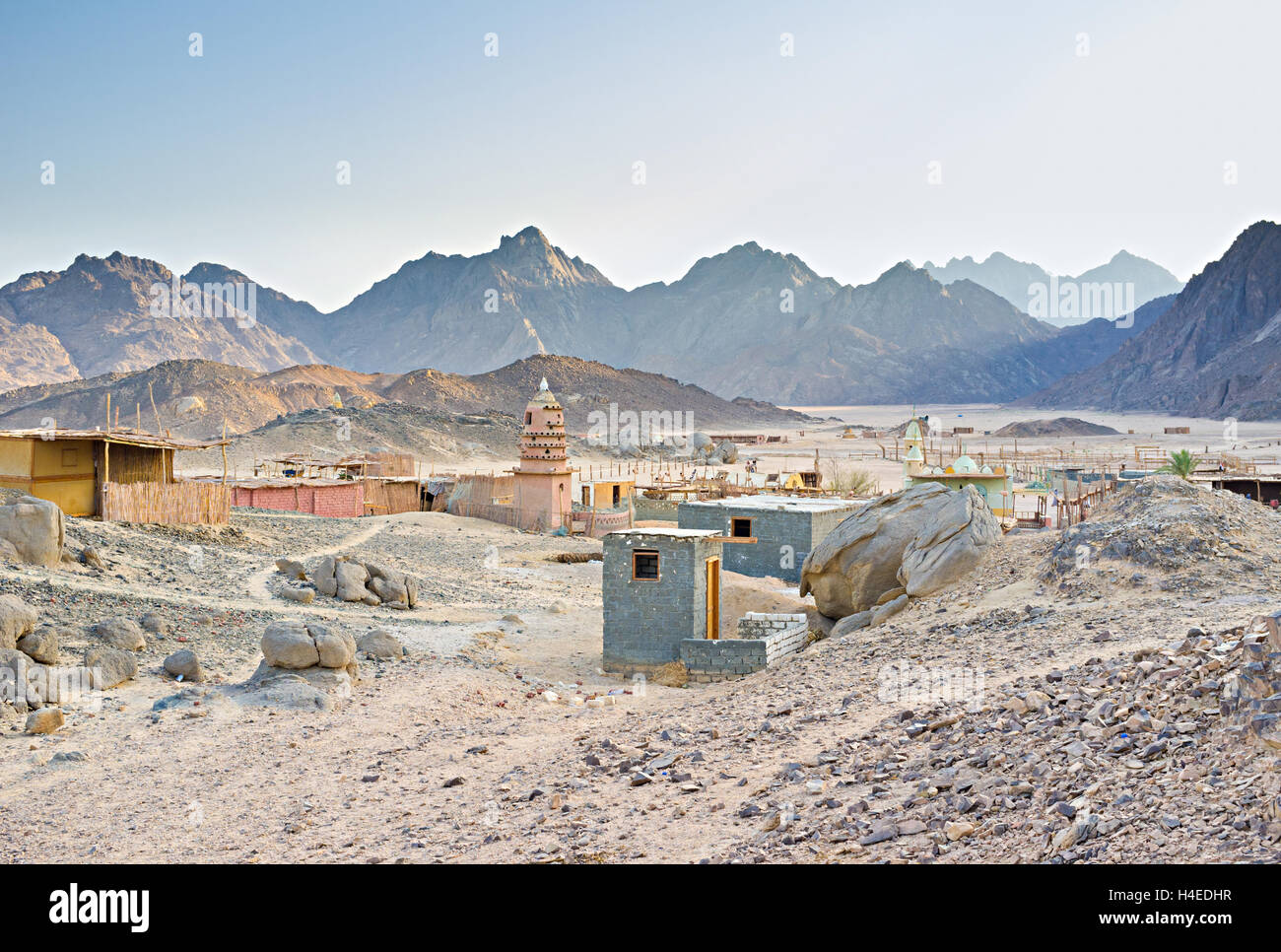 The small Bedouin village in the valley surrounded by hills and rocks, Sahara, Egypt. Stock Photo
