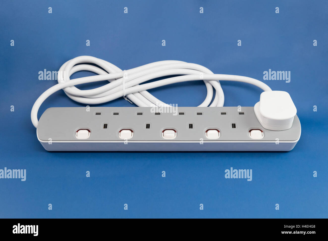 UK extension lead on a blue background Stock Photo