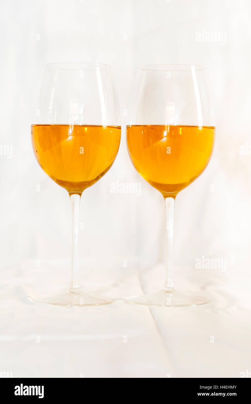 Two stemmed glasses on white wine. Stock Photo