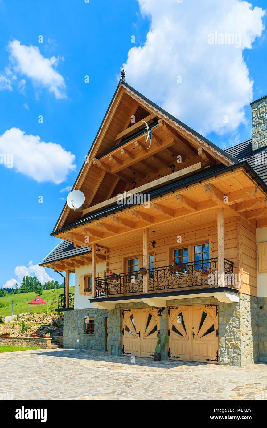 PODHALE REGION, TATRA MOUNTAINS - JUN 10, 2014: typical wooden mountain house near Zakopane in Tatra Mountains, Poland. Stock Photo