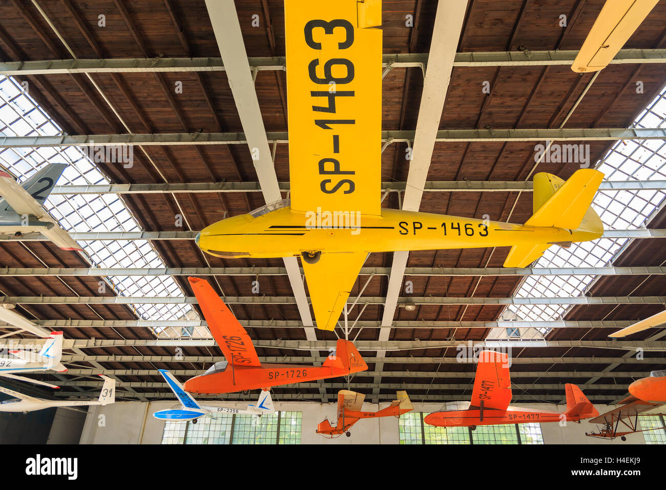 KRAKOW MUSEUM OF AVIATION, POLAND - JUL 27, 2014: old aircrafts hanginig on exhibition in indoor museum of aviation history in Krakow, Poland. In summer often airshows take place here. Stock Photo