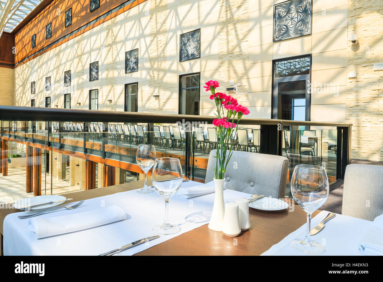 ARLAMOW HOTEL, POLAND - AUG 3, 2014: tables in beautiful open lobby restaurant in Arlamow Hotel. This luxury resort was owned by Stock Photo