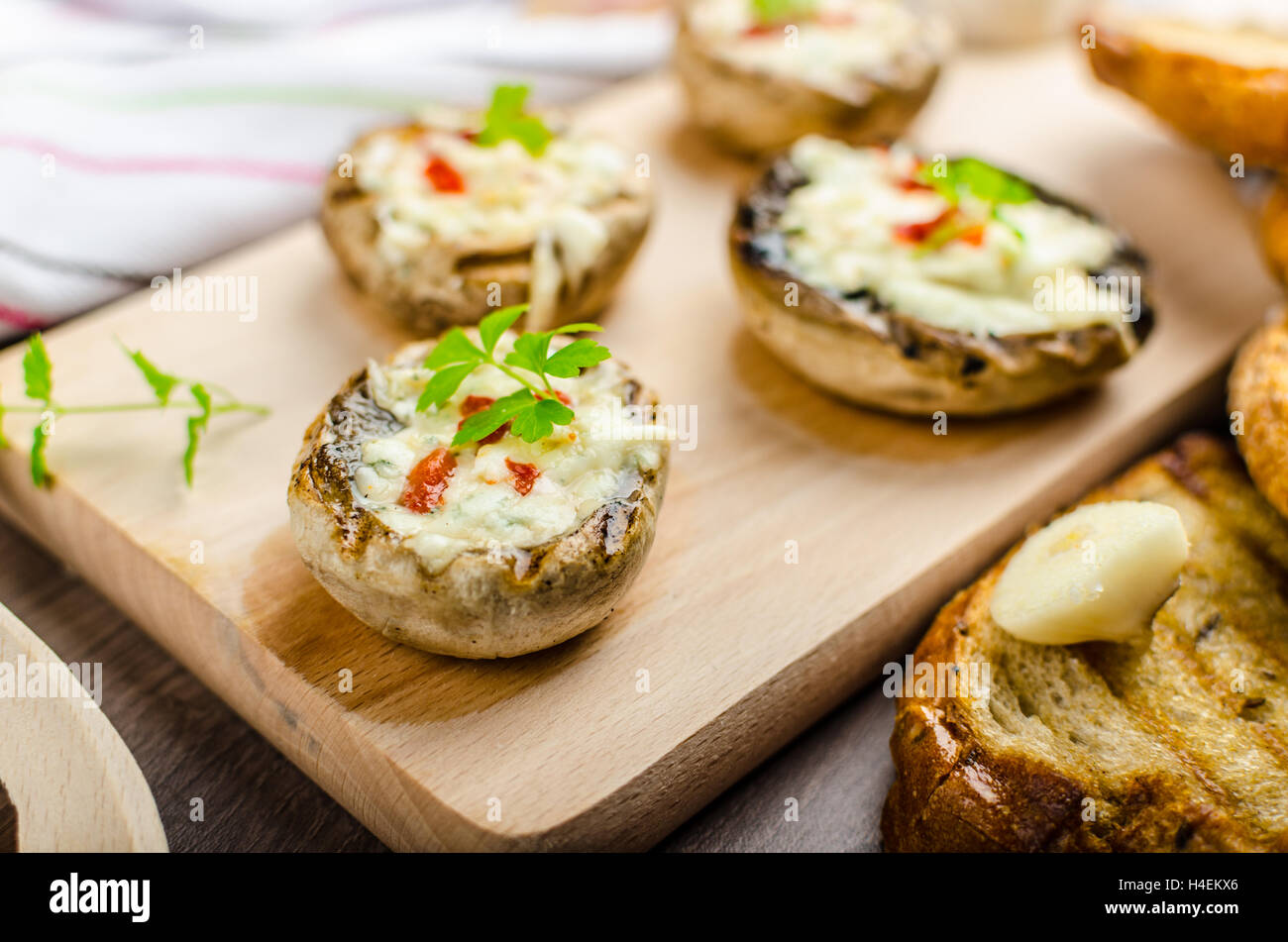Grilled mushrooms stuffed with blue cheese and chilli and garlic toast