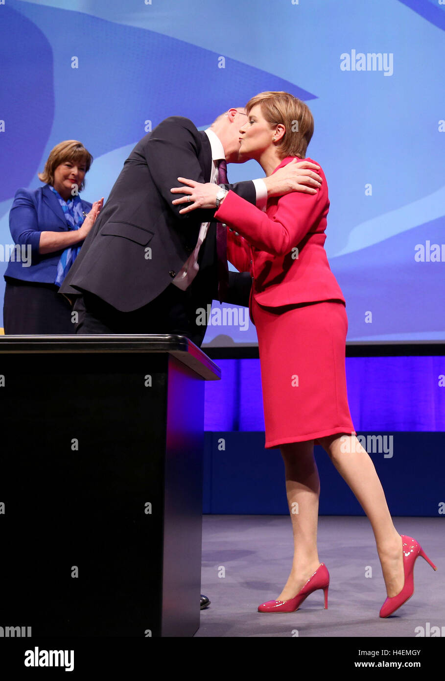 First Minister of Scotland Nicola Sturgeon kisses Deputy First Minister John Swinney after giving her address at the SNP autumn conference in Glasgow. Stock Photo