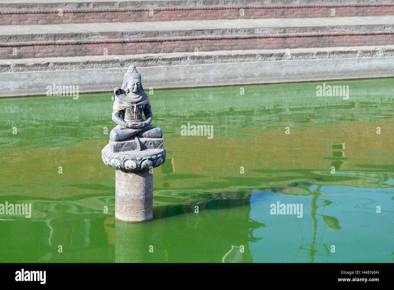 Buddha statue in a green pond, Bhaktapur, Nepal Stock Photo