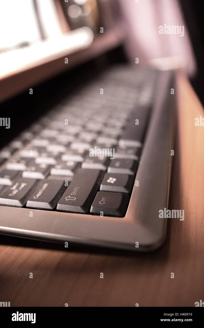 computer keyboard on the table in the light of the monitor Stock Photo