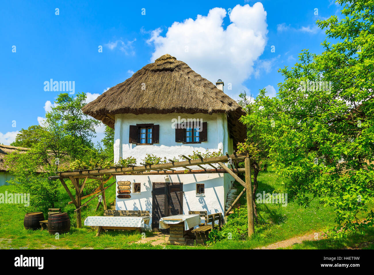 BURGENLAND, AUSTRIA - APR 30, 2014: rustic cottage in countryside landscape of Burgenland during spring time. This region of Austria is famous for wine making and is most sunny in whole Austria. Stock Photo