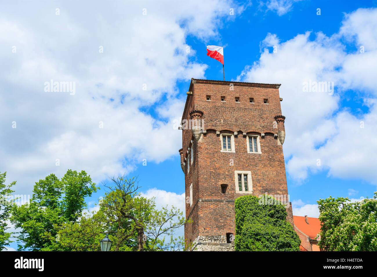 White and red Polish flag on top of Wawel castle tower in Krakow, Poland Stock Photo