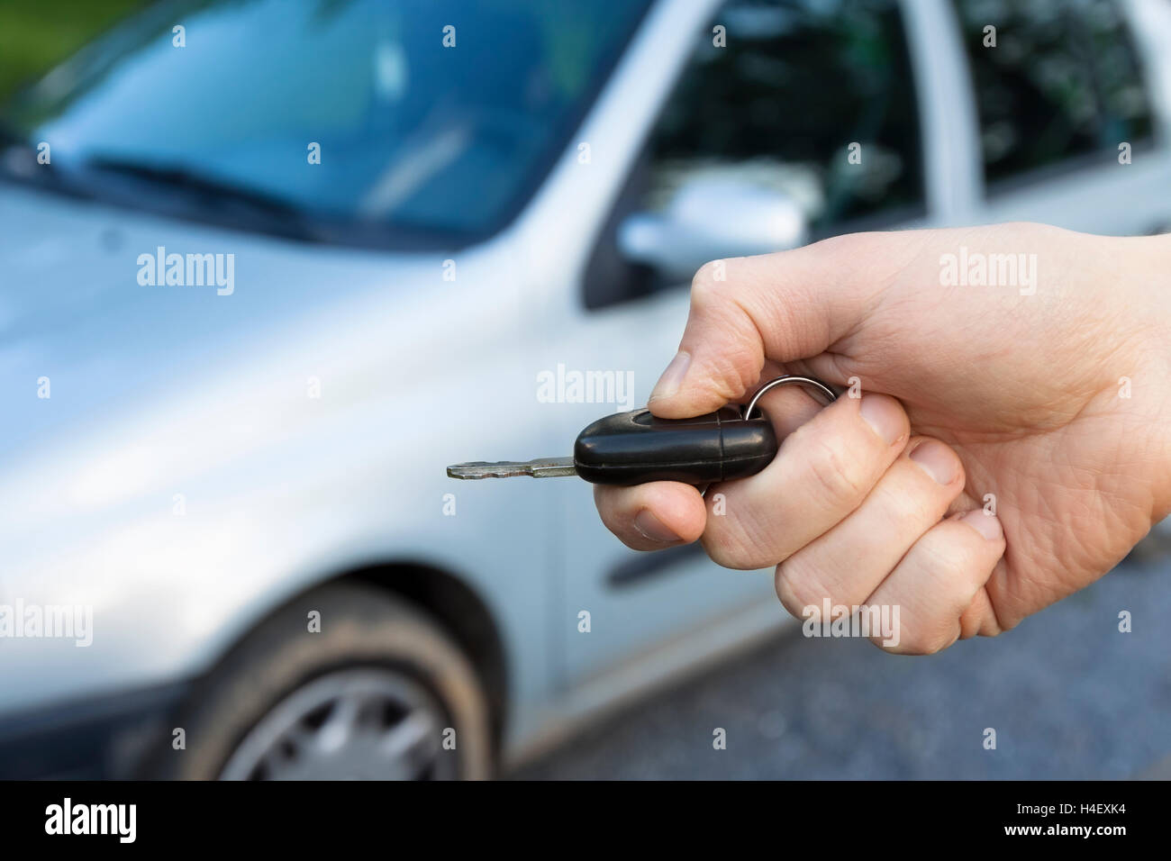 Car keys in hand to unlock Stock Photo