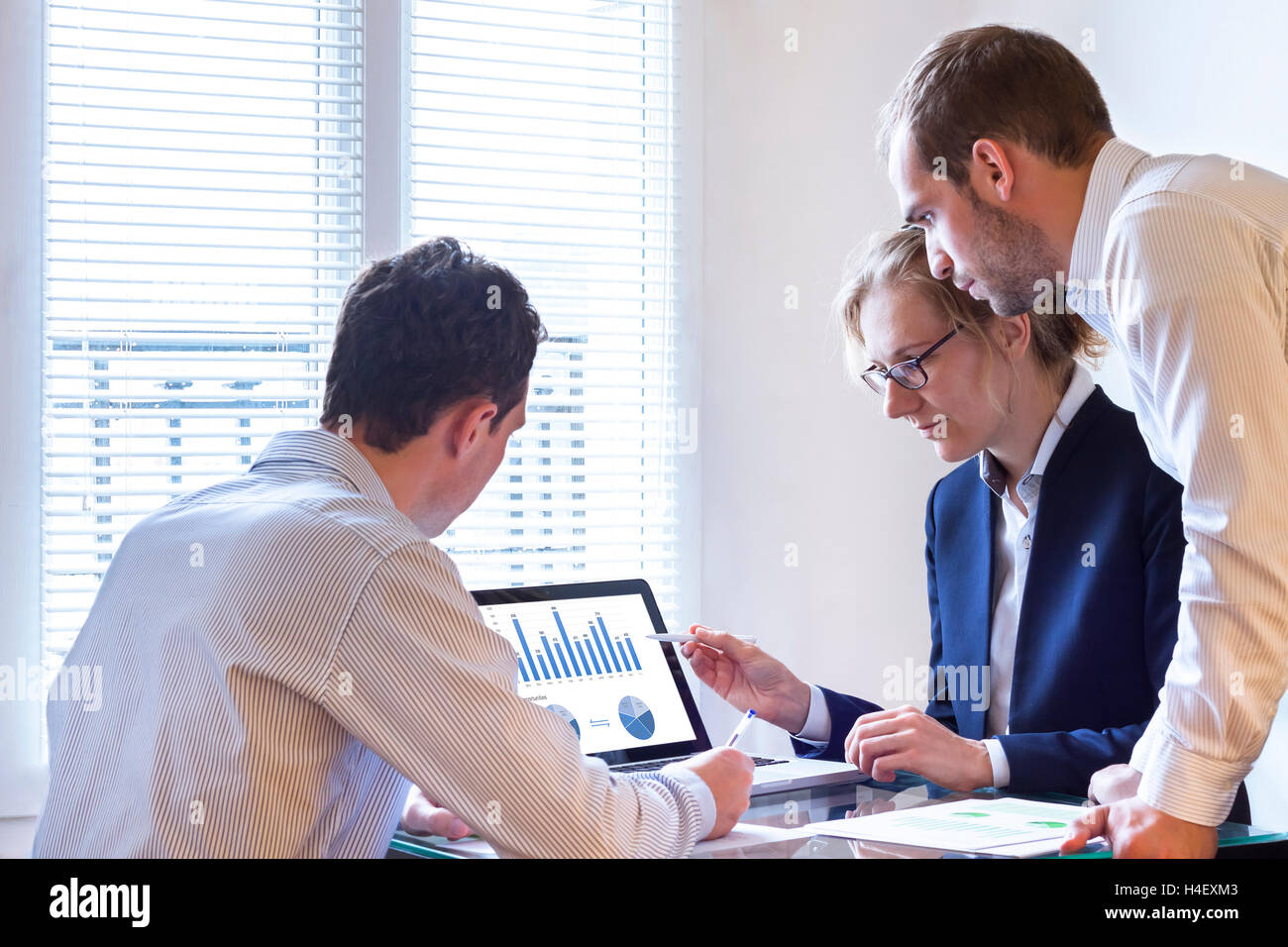 Business meeting with laptop and charts Stock Photo