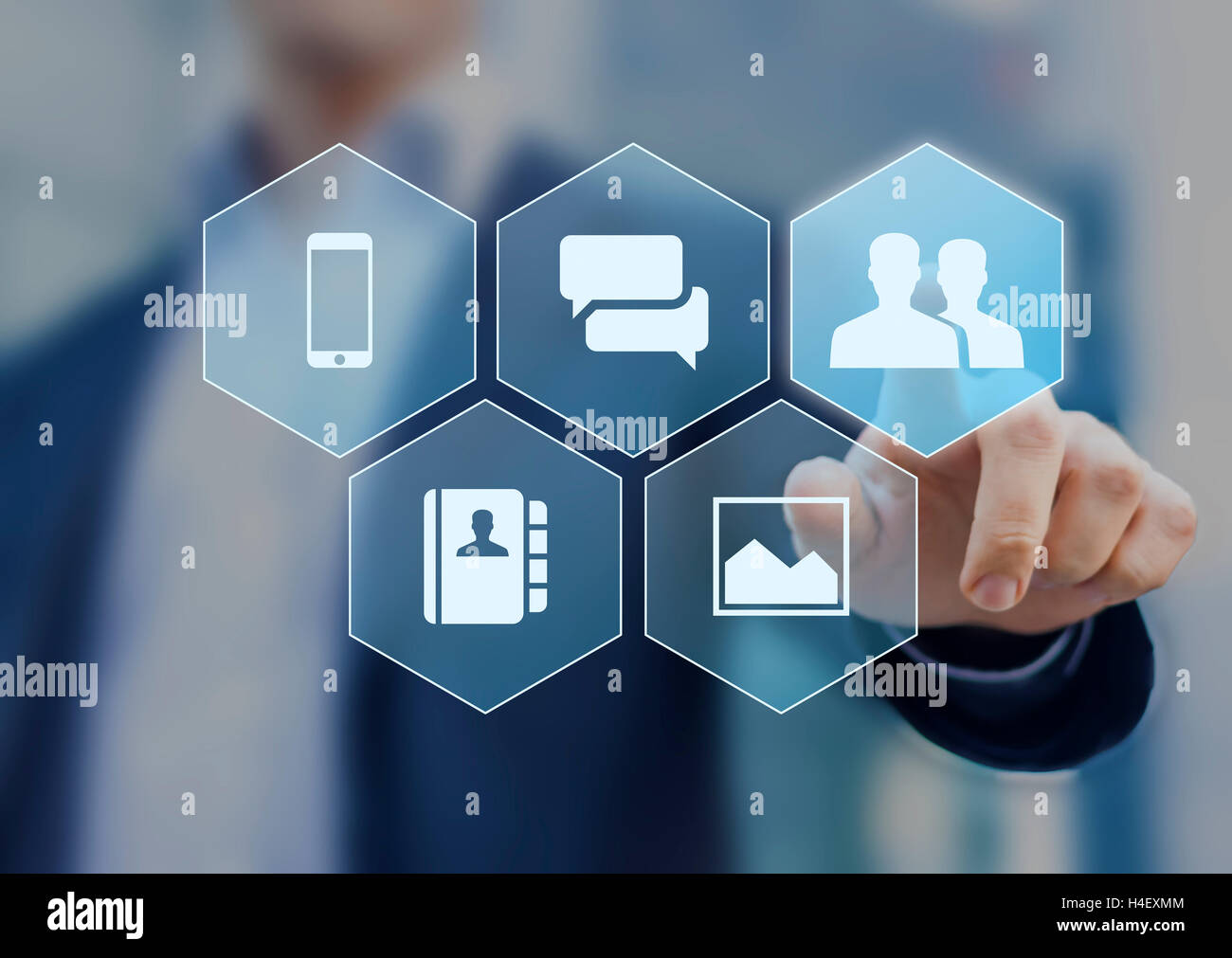 Social network icons on virtual screen buttons with a person in background Stock Photo