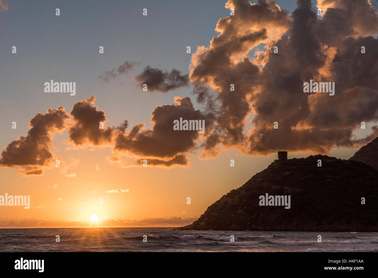 Sunset on the beach with Spanish tower in the background, Porto Ferro, Sardinia, Italy Stock Photo