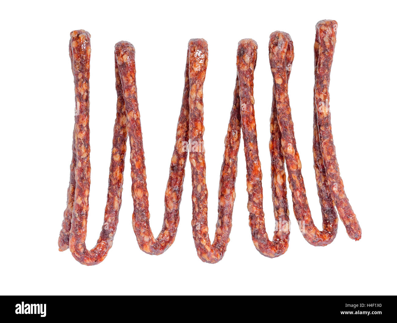 tasty delicious dried bundle red sausages, salami is isolated on white background, close up Stock Photo