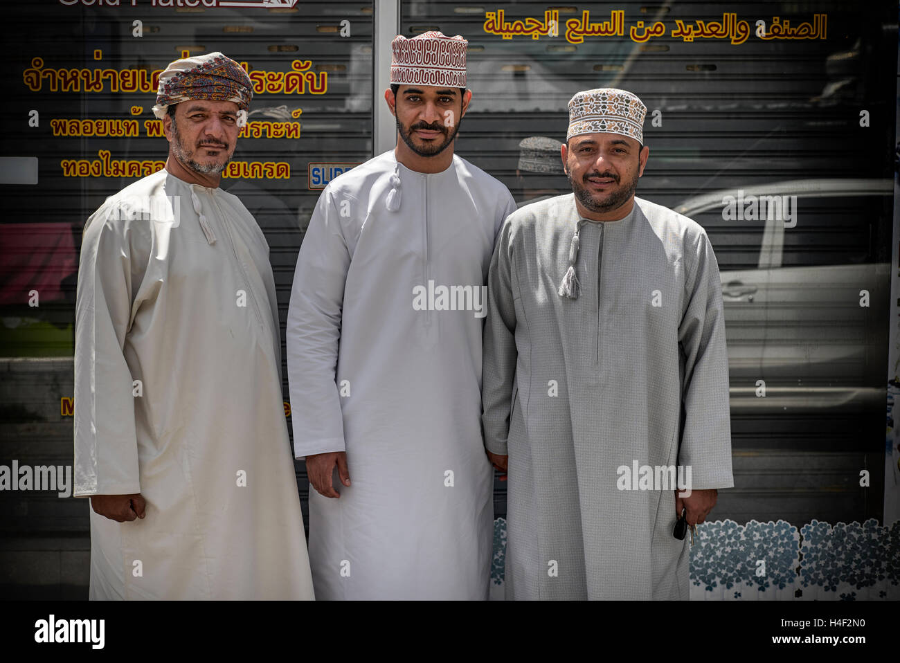 Omani people. Three men from Oman in traditional dress known as dishdasha Stock Photo