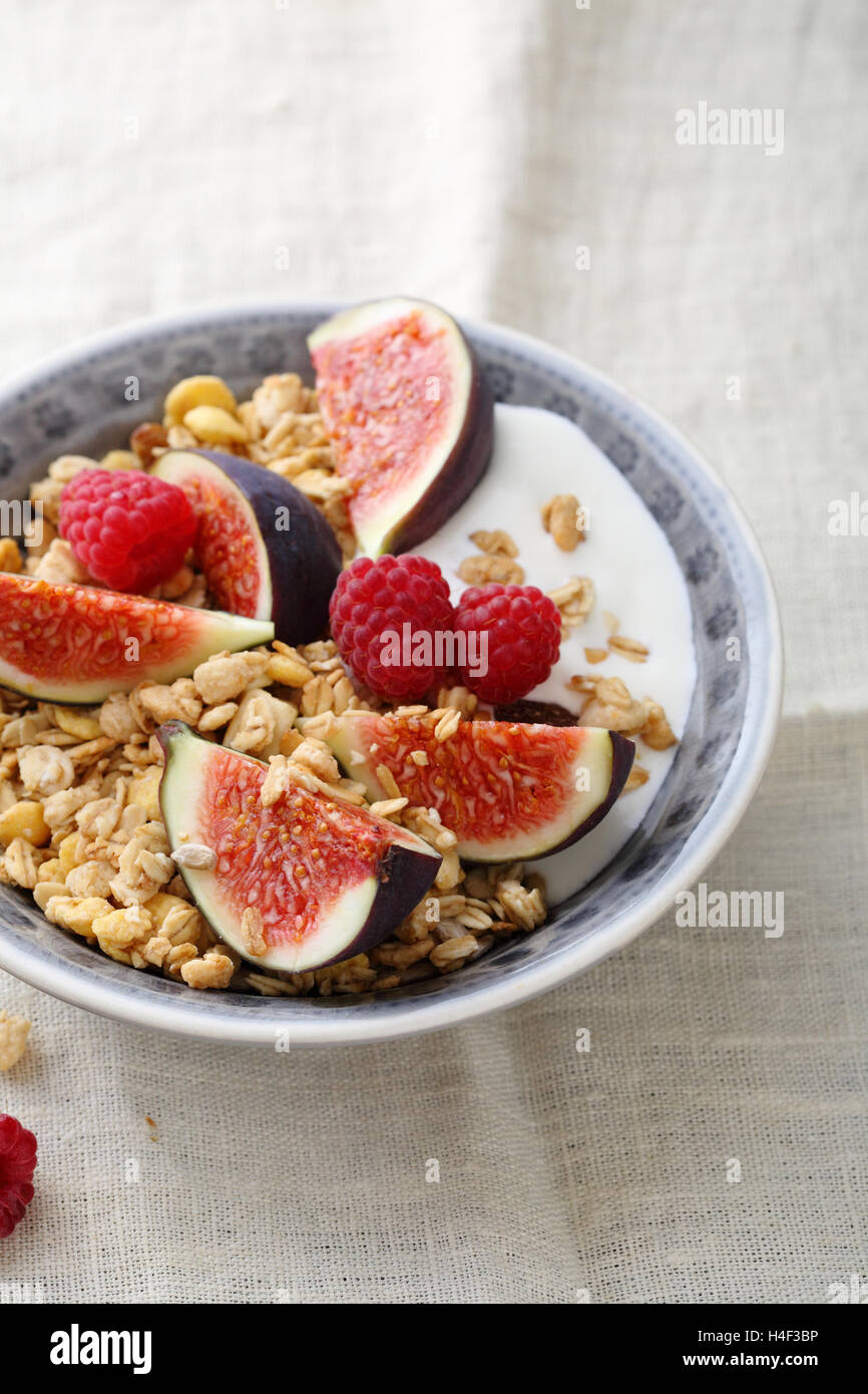 Granola breakfast with figs and raspberry, food closeup Stock Photo
