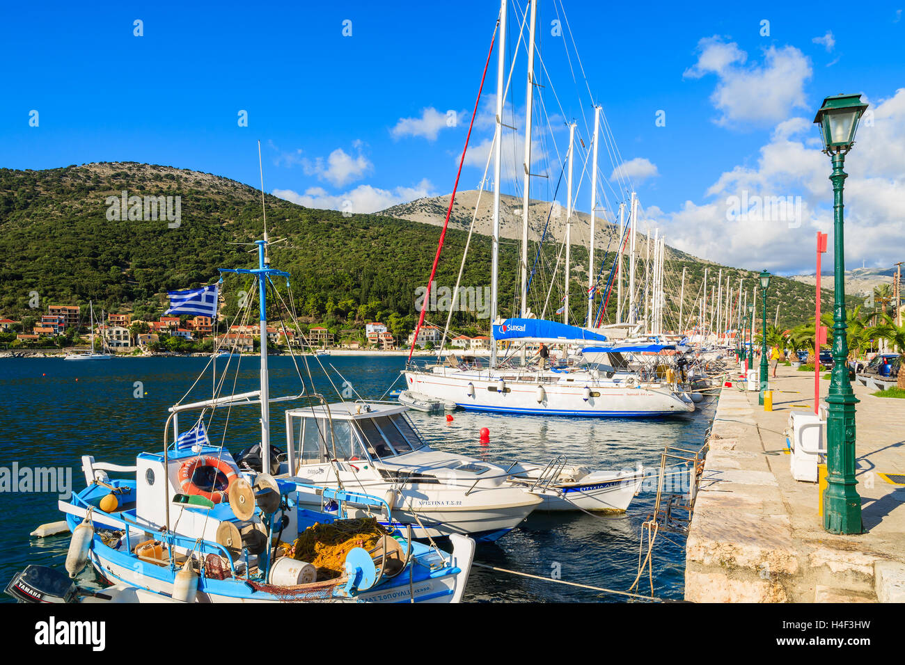 AGIA EFIMIA PORT, KEFALONIA ISLAND - SEP 16, 2014: fishing boats and yachts mooring in Greek port of Agia Efimia on coast of Kefalonia island. Yachting is a popular holiday activity on Greeks islands. Stock Photo