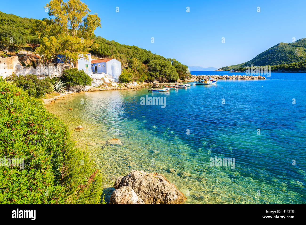View of bay with old house and fishing boats, Kefalonia island, Greece Stock Photo