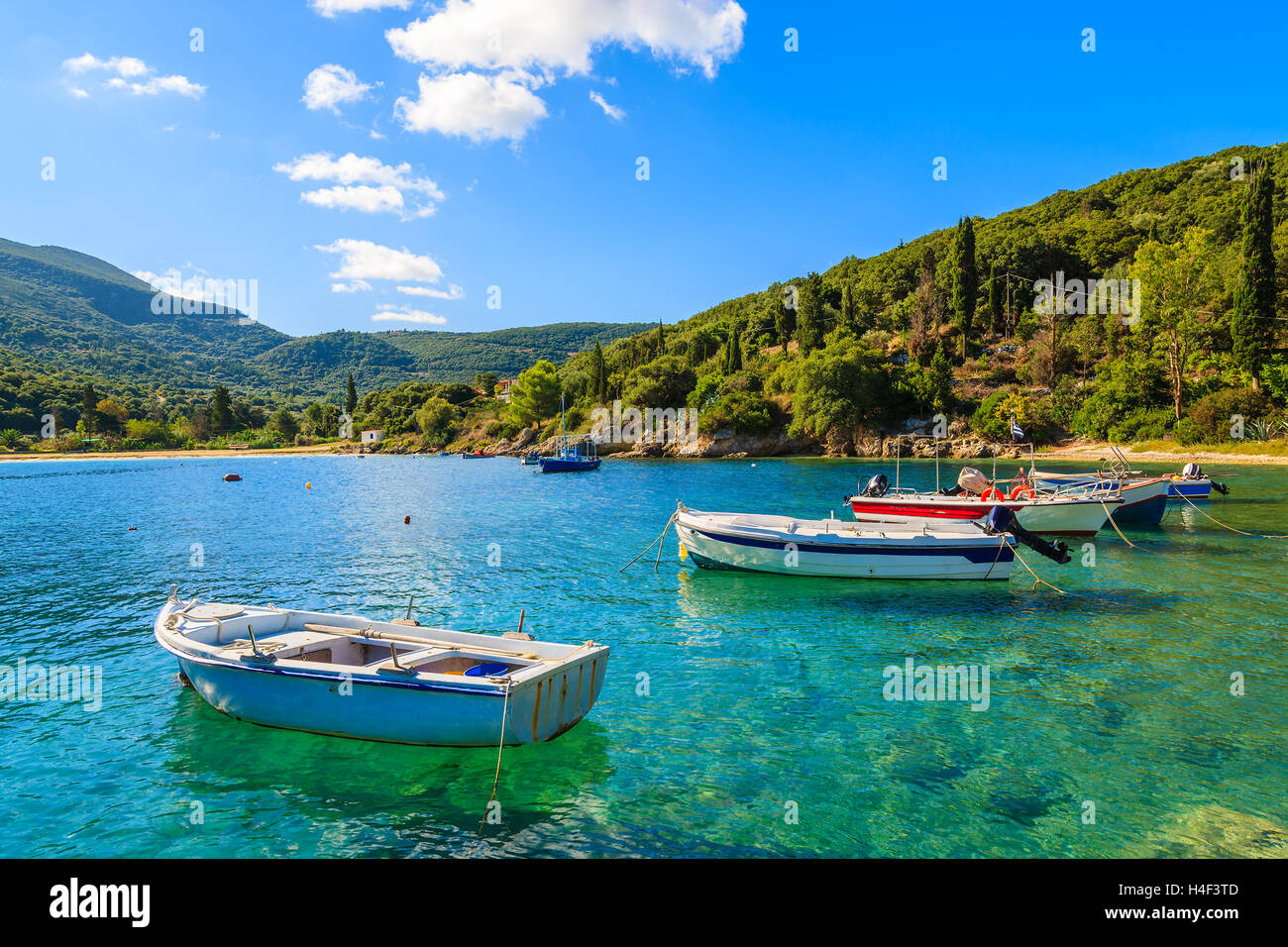 Greek fishing boats on turquoise sea water in beautiful bay, Kefalonia island, Greece Stock Photo