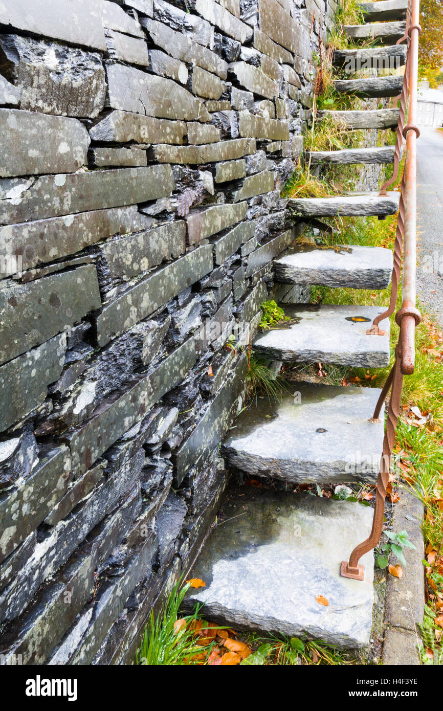 Set of cantilevered steps, made of slate ascending wall. Stock Photo