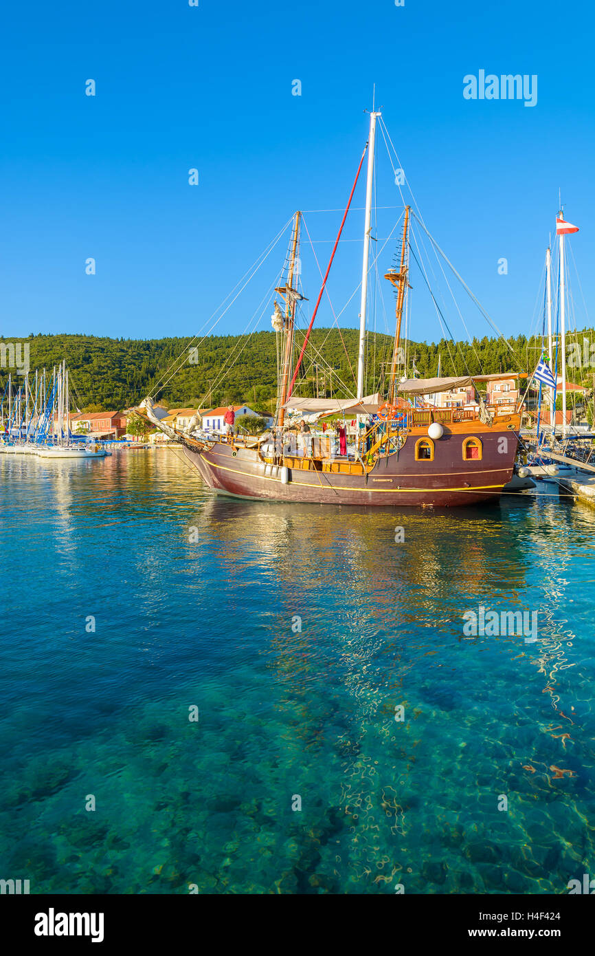 Traditional wooden galleon sailing boat on turquoise sea in Fiskardo