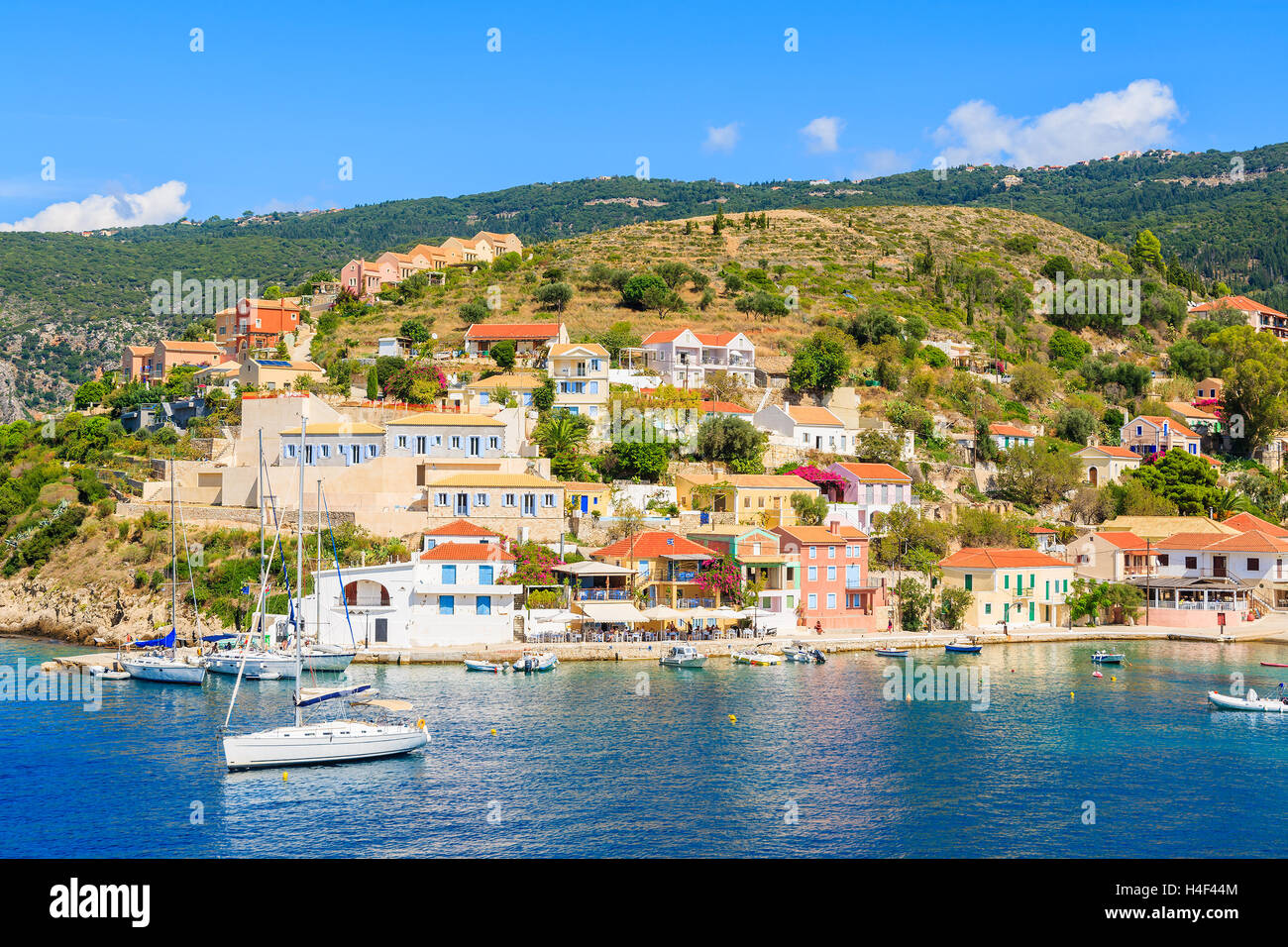 Colorful houses of Assos village and yacht boats in port on Kefalonia island, Greece Stock Photo