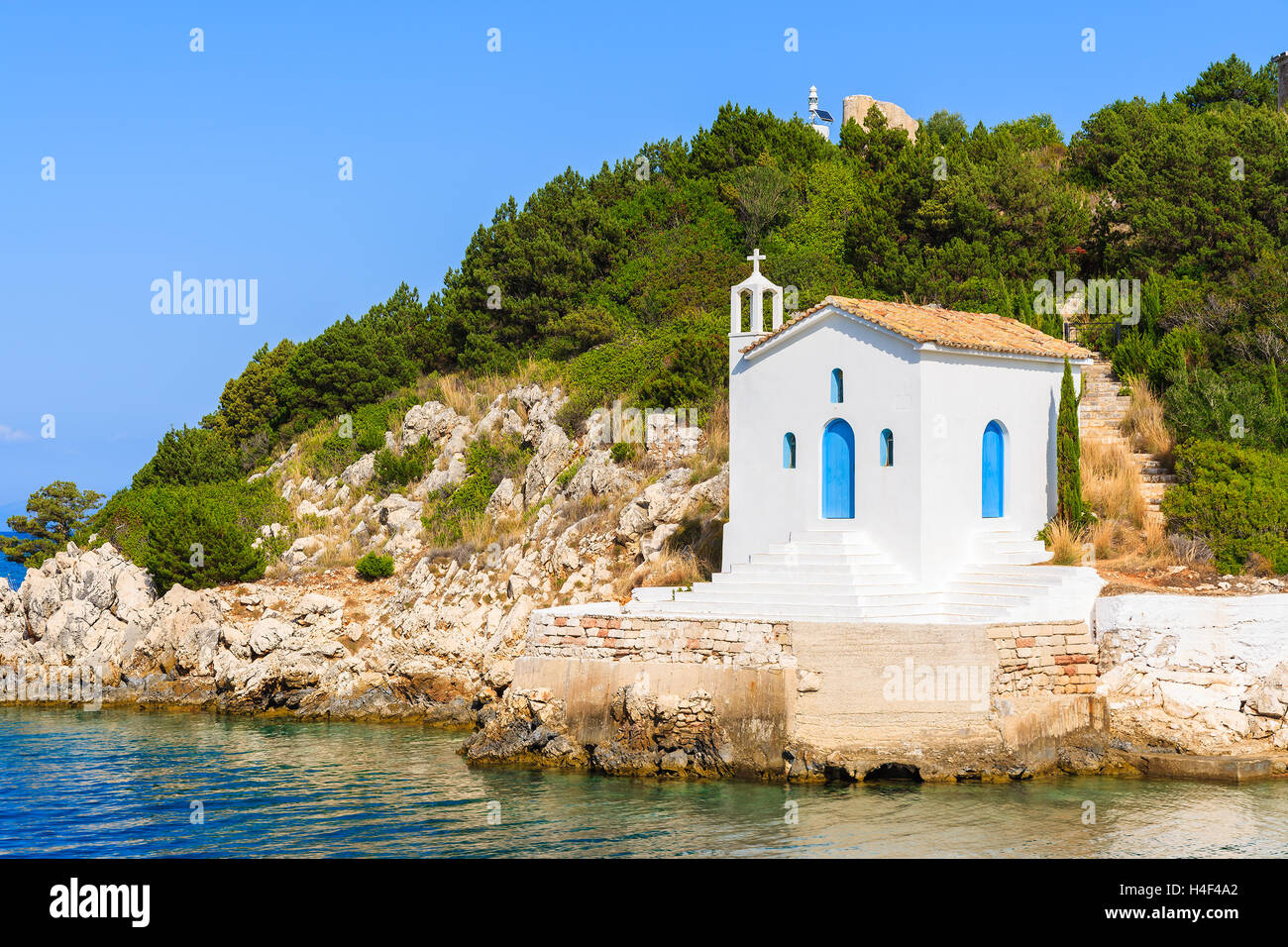 Small white church on coast of Ithaka island near Vathi town, Greece Stock Photo