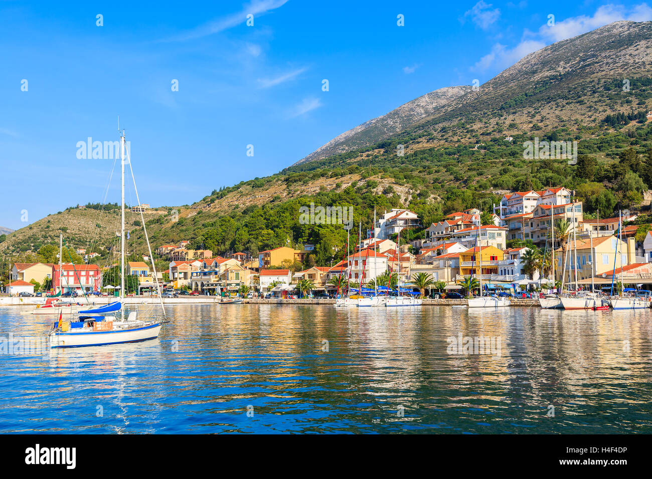 Yacht boat on sea and view of Agia Efimia village on Kefalonia Island, Greece Stock Photo