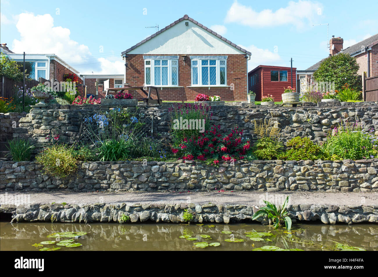 Back garden of bungalow on Trent & Mersey canal Stock Photo