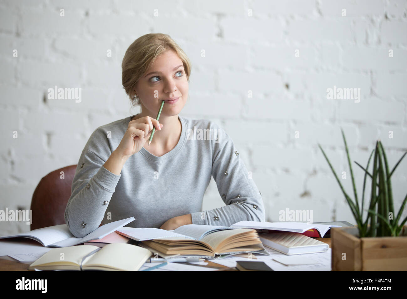Portrait of a dreaming student woman at the desk Stock Photo Alamy