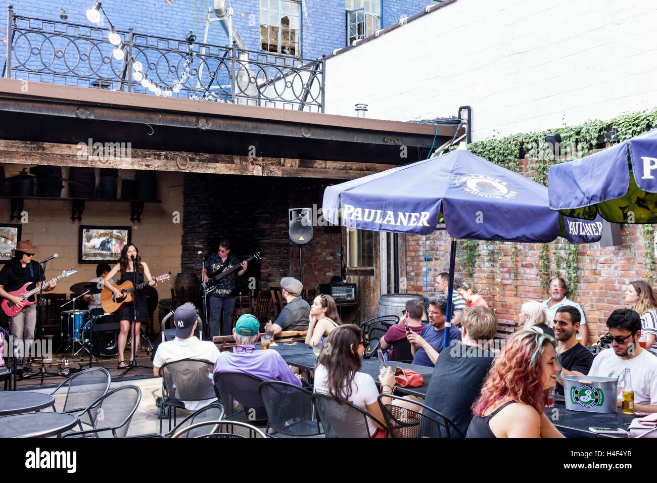 New York City,NY NYC Queens,Long Island City,LIC Bar,L.I.C.,patio,outdoor,live music,entertainment,performers,musicians,band,playing,singing,adult,adu Stock Photo