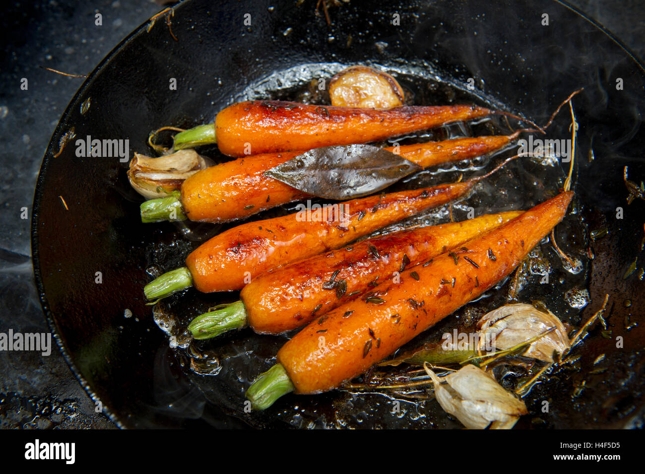 carrots cooking in a shallow frying pan Stock Photo Alamy