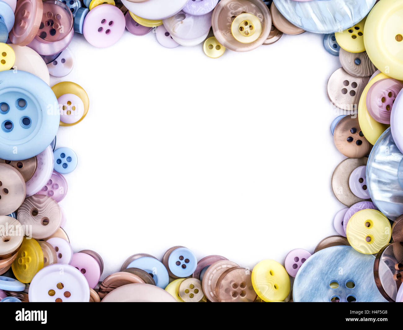 Framework arranged from apparel buttons in different size and colors with white copy space Stock Photo